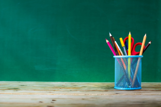 Back to school concept. colored pencil, and supplies  on wooden table