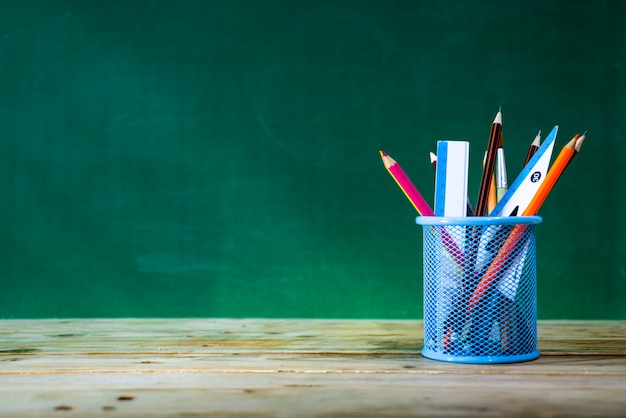 Back to school concept. colored pencil, and supplies  on wooden table