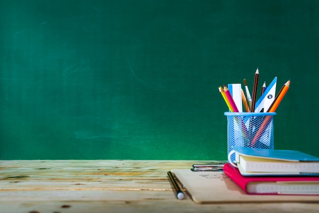 Back to school concept. colored pencil, and supplies  on wooden table