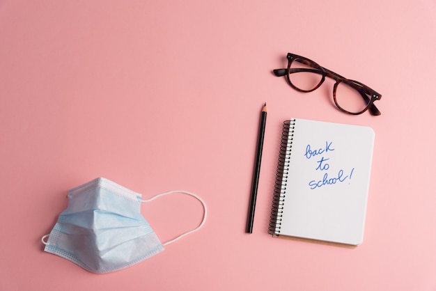 Photo back to school concept desk with disposable face mask