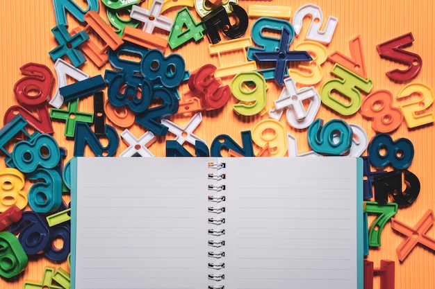 Photo back to school concept. notebook and education equipment on orange background.