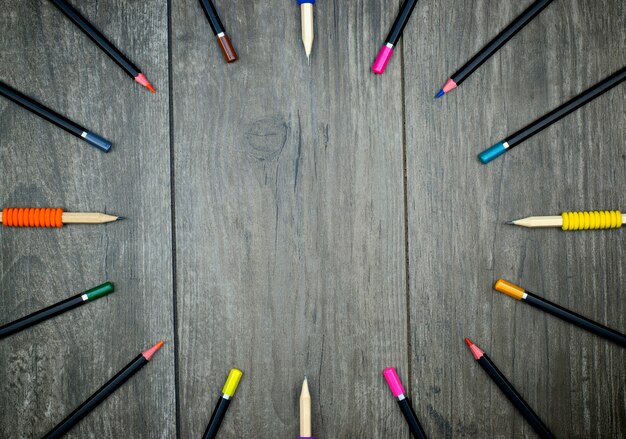 Photo back to school concept: pencils and crayons on a wooden background