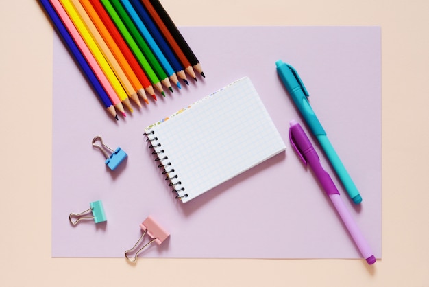 Back to school concept - school office supplies. Top view of wooden office table with colorful supplies and copy space. Design and art concept