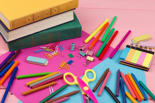 Back to school concept school supplies books markers crayons pink and blue paper scissors eraser and other accessories