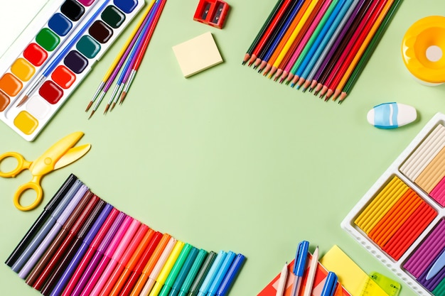 Back to school concept. School supplies on a pasteltable