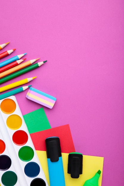 Back To School concept. School supplies on pink background, top view