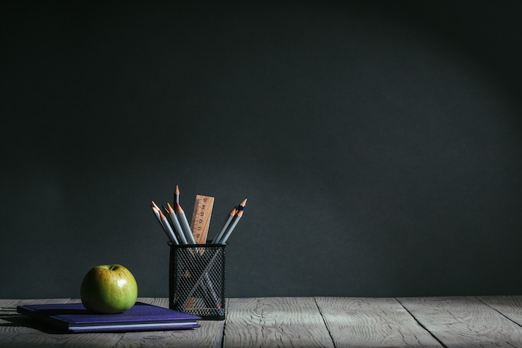 Photo back to school concept. stationery with fruit on the table