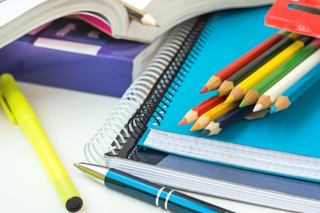 Back to School Concept. Supplies Stack of Copybooks Multicolored Pencils Highlighter