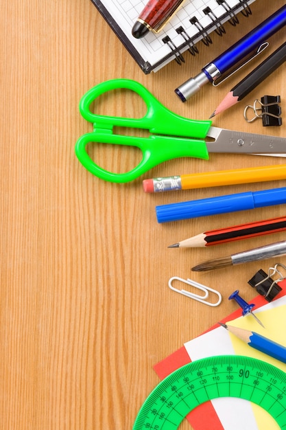 Back to school concept and supplies on wood background