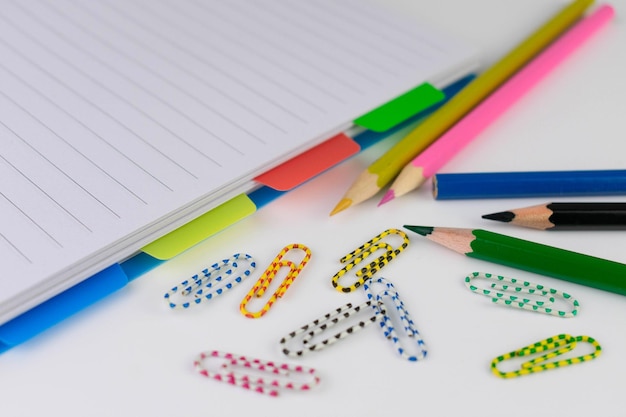 Back to school concept with school supplies Notepad pencils and paper clips