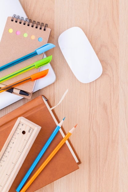 Photo back to school concept with school supplies on wooden table .