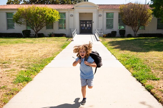 Photo back to school dynamic images that go back to the conceptual school cute kid with backpack running and going to school kids education concept