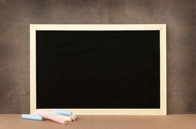 Photo back to school and education concept empty surface of blackboard and chalk hearby