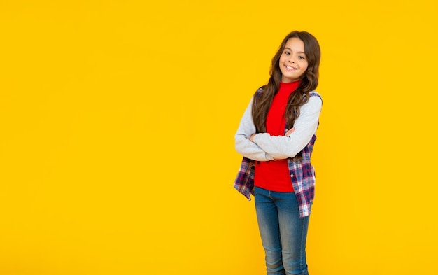 Back to school female fashion model kid in casual clothes on yellow background