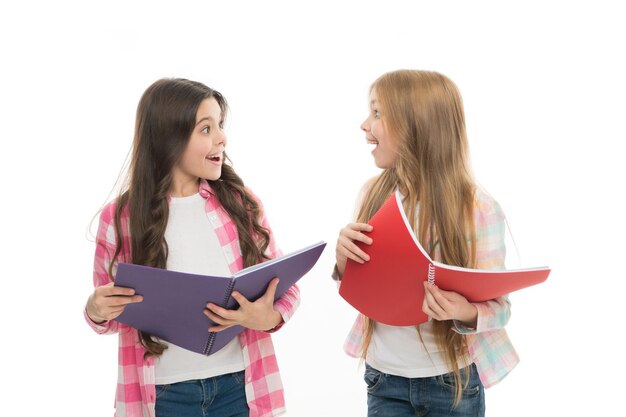 Back to school goods Cute little girls holding school exercise books Adorable small school children with open note books Perfect books for using at school lessons