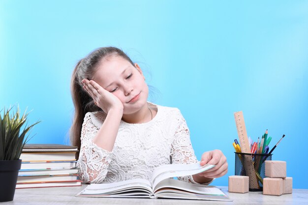 Back to school .happy cute industrious child is sitting at a desk indoors. kid is learning in class.quarantine.kid is learning in home.