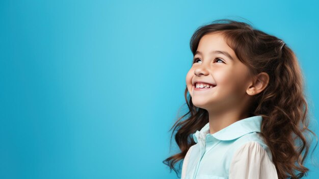 Back to school happy young girl on a blue