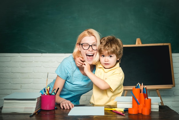 Back to school Home schooling or private school Female teacher and schoolboy in class at school Elementary school Hard exam