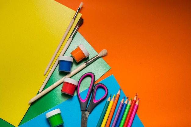 Back to school items for the school on a orange table