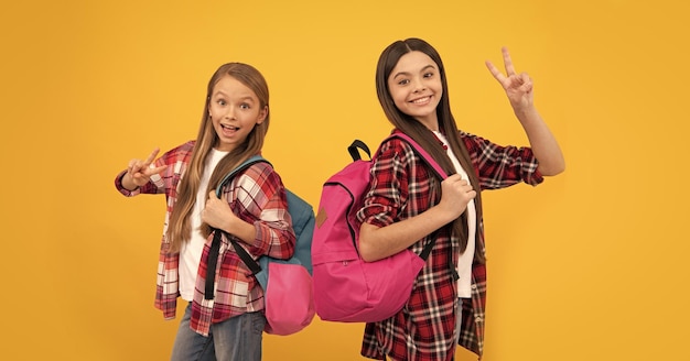 Back to school knowledge day concept of education kids with long hair on yellow background