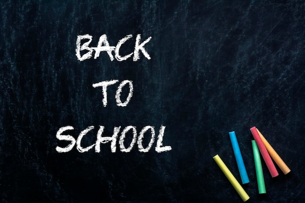 Back to school lettering over chalkboard black background