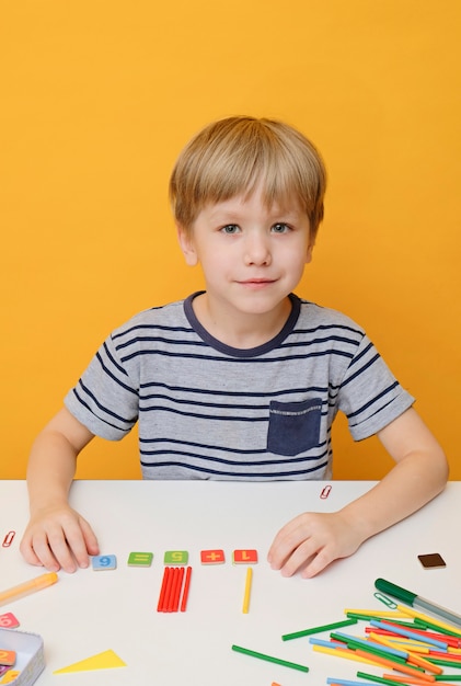 Back to school. Little boy preparing for elementary school doing simple Mathematics exercises