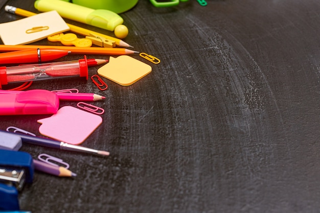 Photo back to school multicolored school supplies rainbow on school board flatlay copyspace