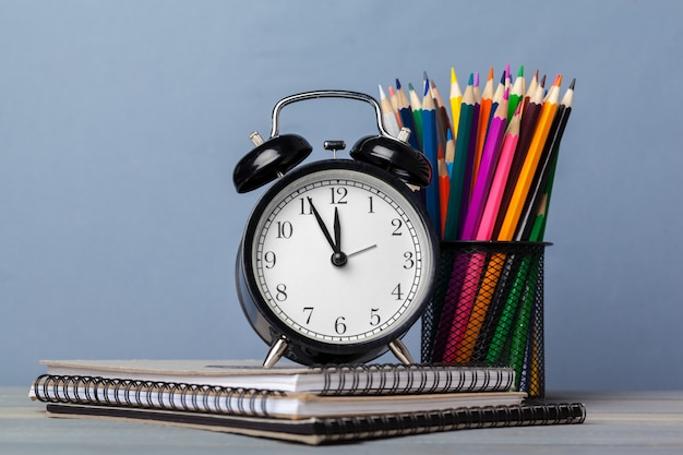 Back to school. Notepads and alarm clock