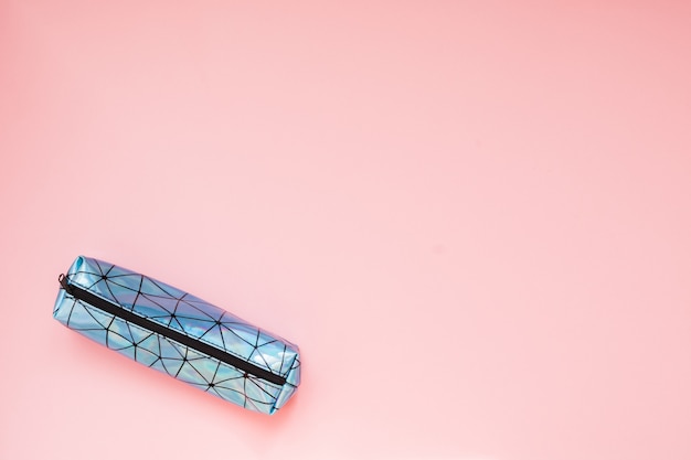 Back to school. Pencil case with school supplies on pink table