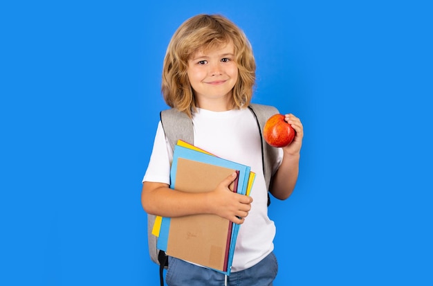 Back to school school child with book on isolated background portrait of happy smiling school kid po