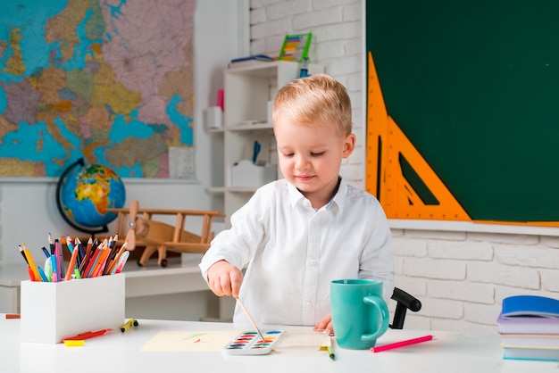 Back to school School interiors School kids against green chalkboard Individual tutoring Education Children learning Elementary school