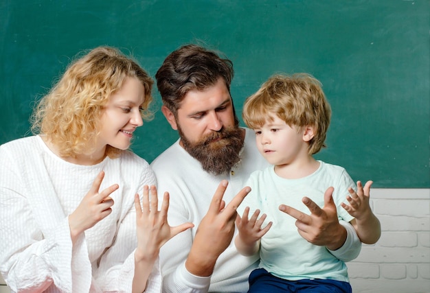 Back to school School kids Mother father and son together schooling Pupil of primary school study indoors