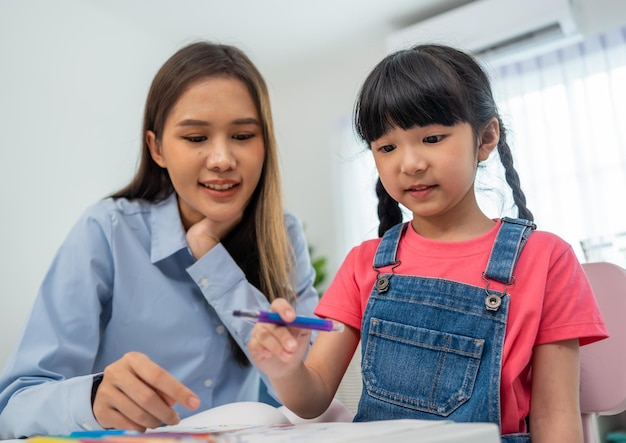 Back to school and summer course. Kindergarten teacher with children drawing and coloring.