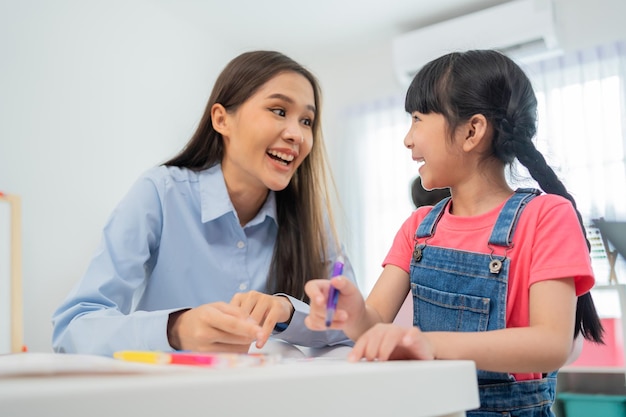 Back to school and summer course. Kindergarten teacher with children drawing and coloring.