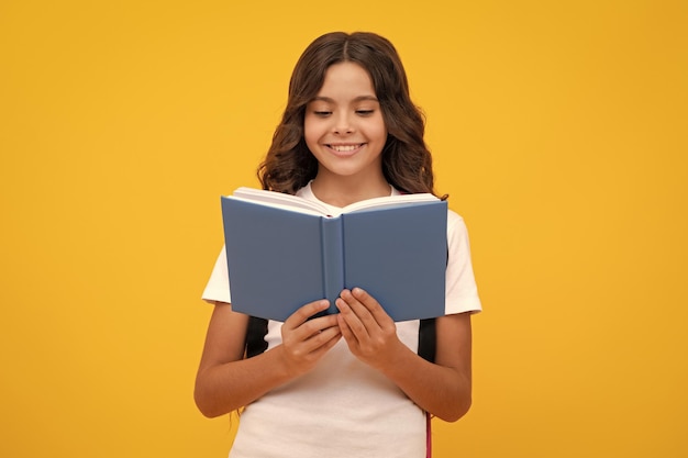 Back to school Teenager school girl hold book and copybook ready to learn School children with school bag on isolated yellow studio background