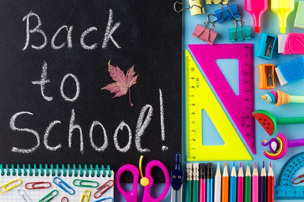 back to school text, school stationary and blackboard.