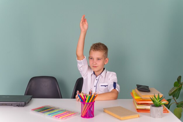 Back to school Thinking child boy writing drawing in notebook sitting at desk and doing homework