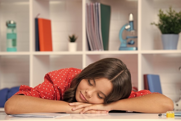 Photo back to school tired and bored teenager schoolgirl