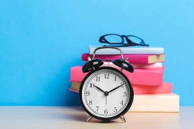 Back to school with books and alarm clock