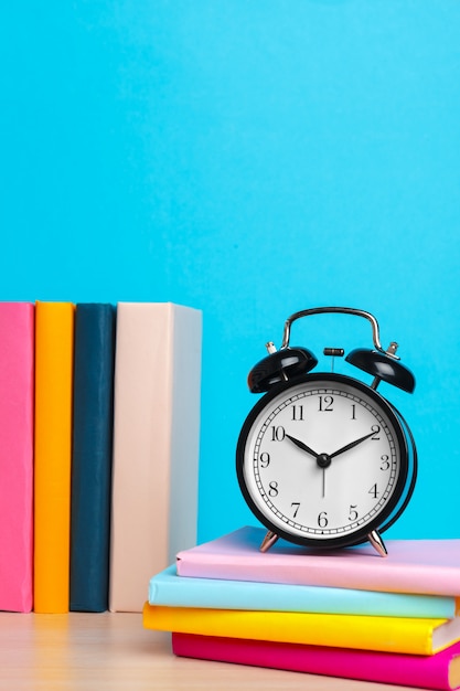 Back to school with books and alarm clock