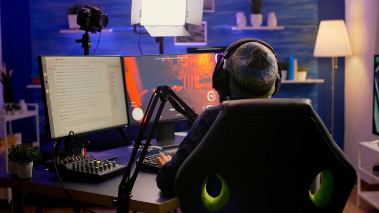 Photo back shot of pro streamer with headphone playing first person shooter video game competition use rgb keypad