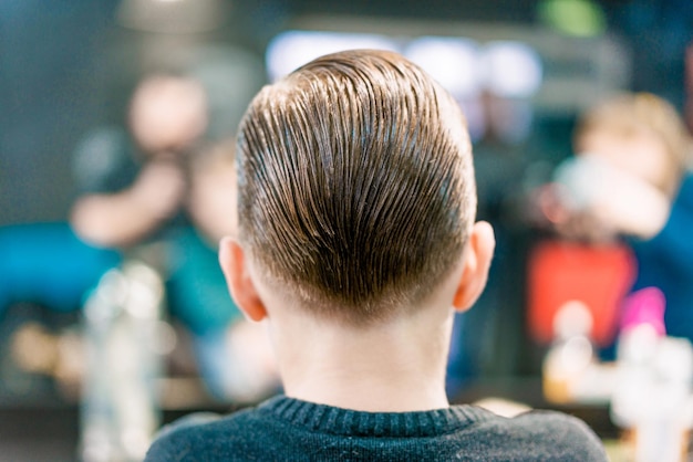 Premium Photo | A back side of boy's new haircut