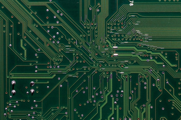 Photo back side of green digital circuit board flat fullframe background and texture
