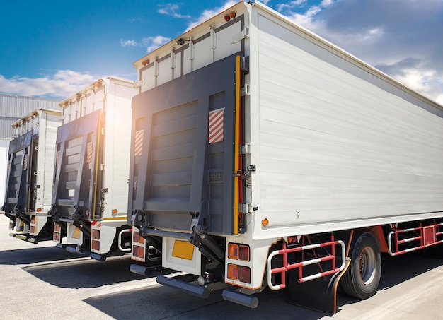 Back side a truck, door hydraulic lift truck on parking at the
warehouse. cargo freight transportation and logistics.