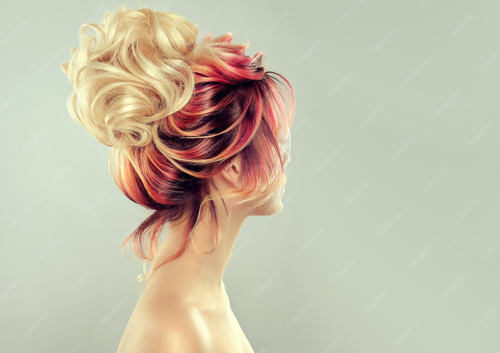 Premium Photo | Back side view on the elegant multi colored painted hairstyle with big blonde hair bun. hues of yellow, red and black colors on the painted hair. Premium Photo | Back side view on the elegant multi colored painted hairstyle with big blonde hair bun. hues of yellow, red and black colors on the painted hair.
