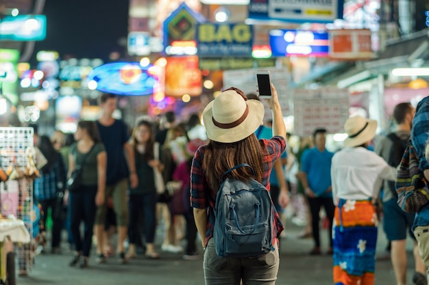 Back side of Young Asian traveling women taking photo