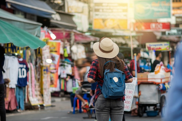 Back side of Young Asian traveling women walking and looking