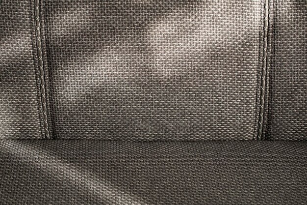 Photo the back of the upholstered furniture sofa is made of fabric with large weaving threads