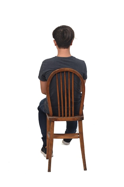 Back view of adolescent sitting on chair