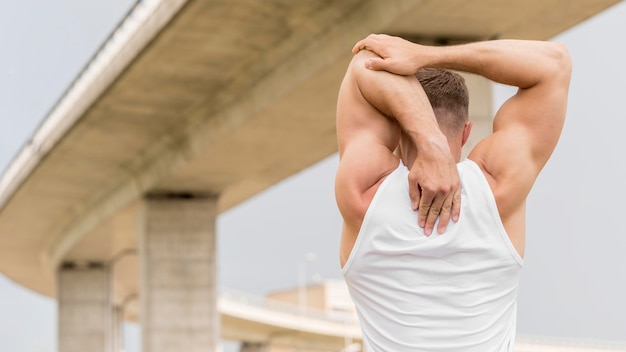 Photo back view athletic man stretching